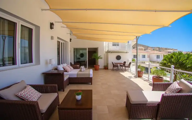 A family enjoys a sunny day at a Cyprus hotel pool, perfect for a relaxing vacation