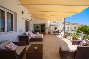 A family enjoys a sunny day at a Cyprus hotel pool, perfect for a relaxing vacation